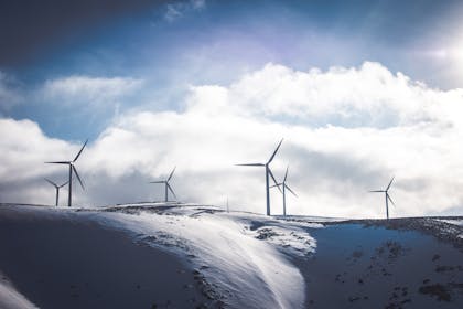 Wind turbines generating green renewable energy on mountain top