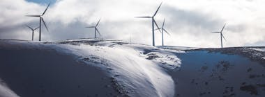 Wind turbines generating green renewable energy on mountain top