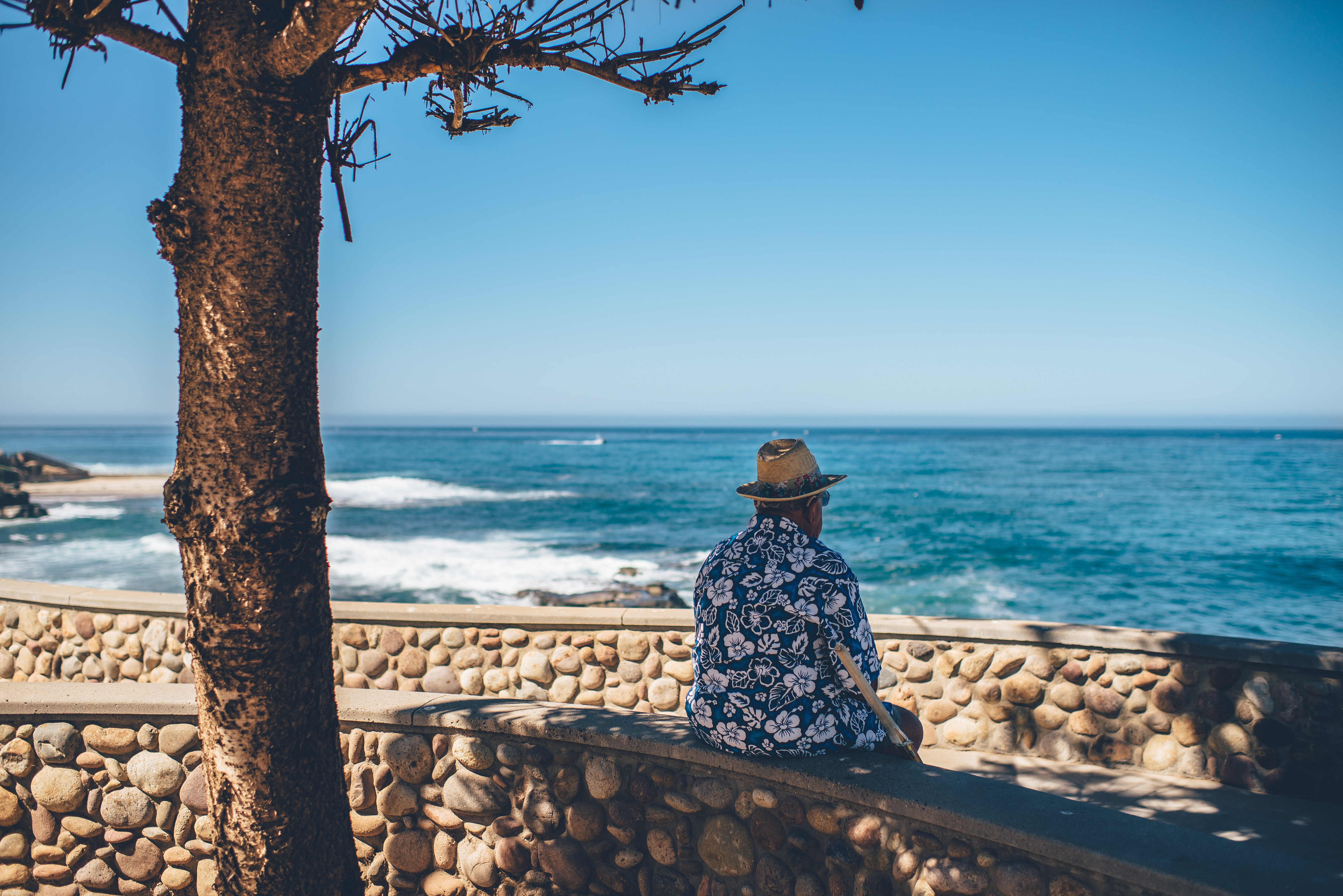 Old man on holiday overlooking the sea