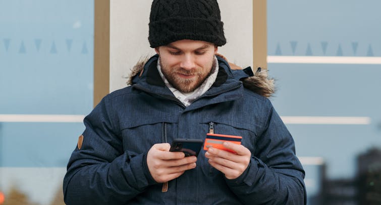 man with credit card and phone