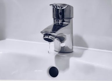 Tap dripping into a basin