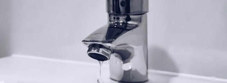 Tap dripping into a basin